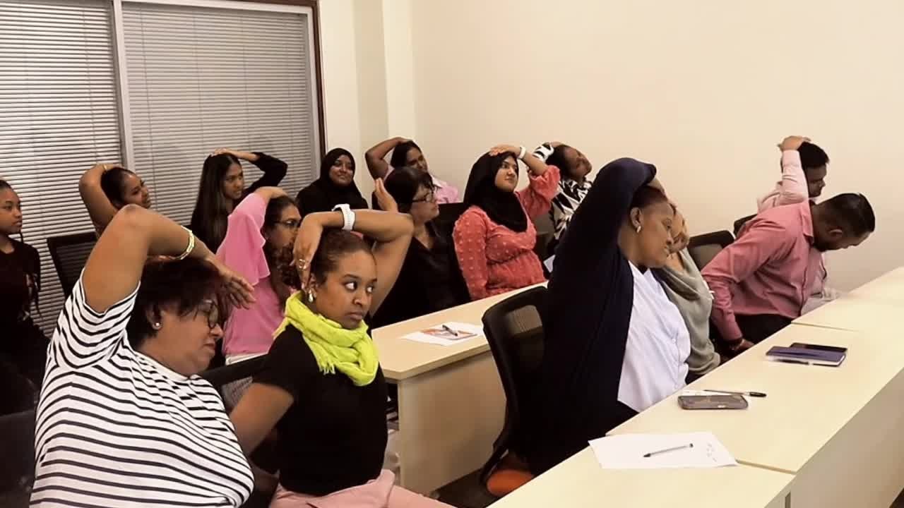 A live PPW seminar — attendees doing a guided neck release